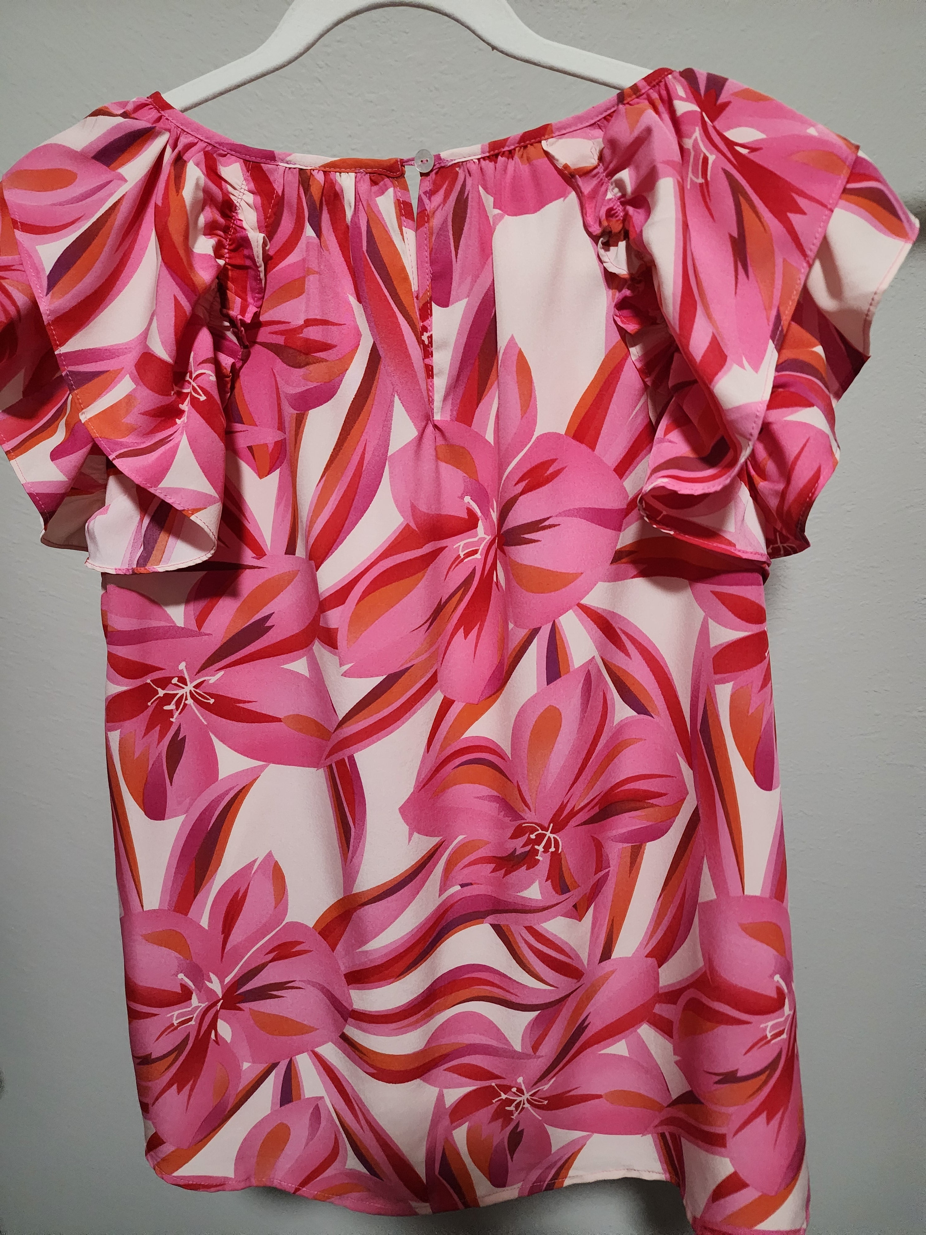 - Fuchsia, Red, Orange, Pink and White Floral Double Ruffle Flounce Shoulder Top
- Print top with U-neck featuring wrinkle, back buttoned closure, layer flounce shoulder, and curved hemline.
- Non-sheer, lightweight.
