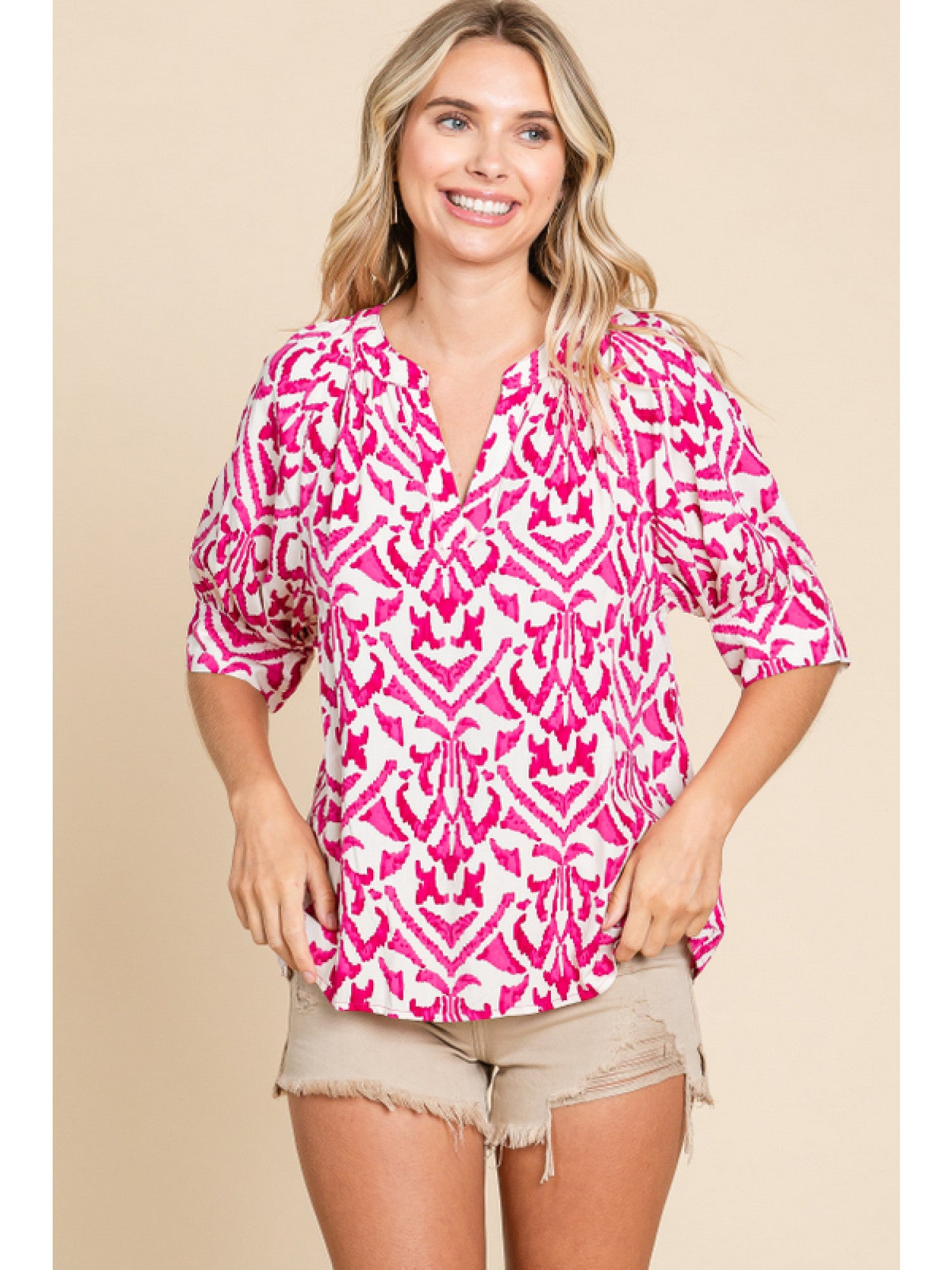 - Fuchsia & White print top with slit neck, half raglan sleeves, and wide band cuffs.
- Non-sheer, lightweight.