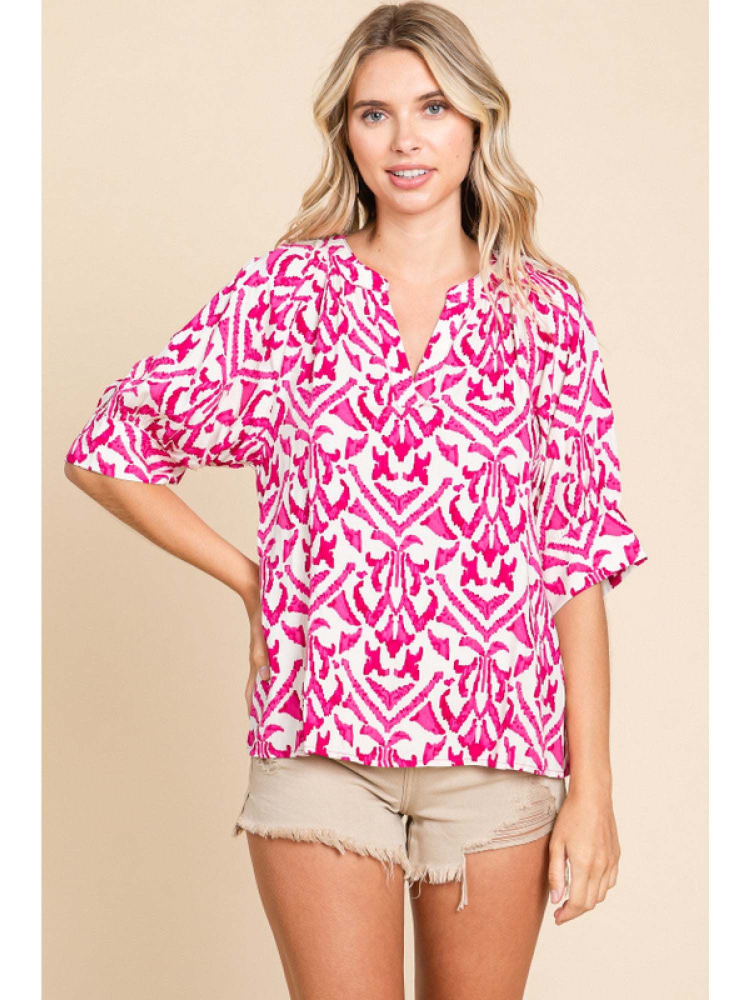 - Fuchsia & White print top with slit neck, half raglan sleeves, and wide band cuffs.
- Non-sheer, lightweight.