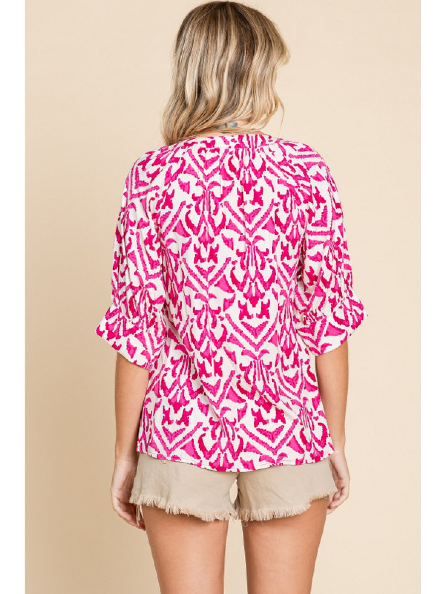- Fuchsia & White print top with slit neck, half raglan sleeves, and wide band cuffs.
- Non-sheer, lightweight.