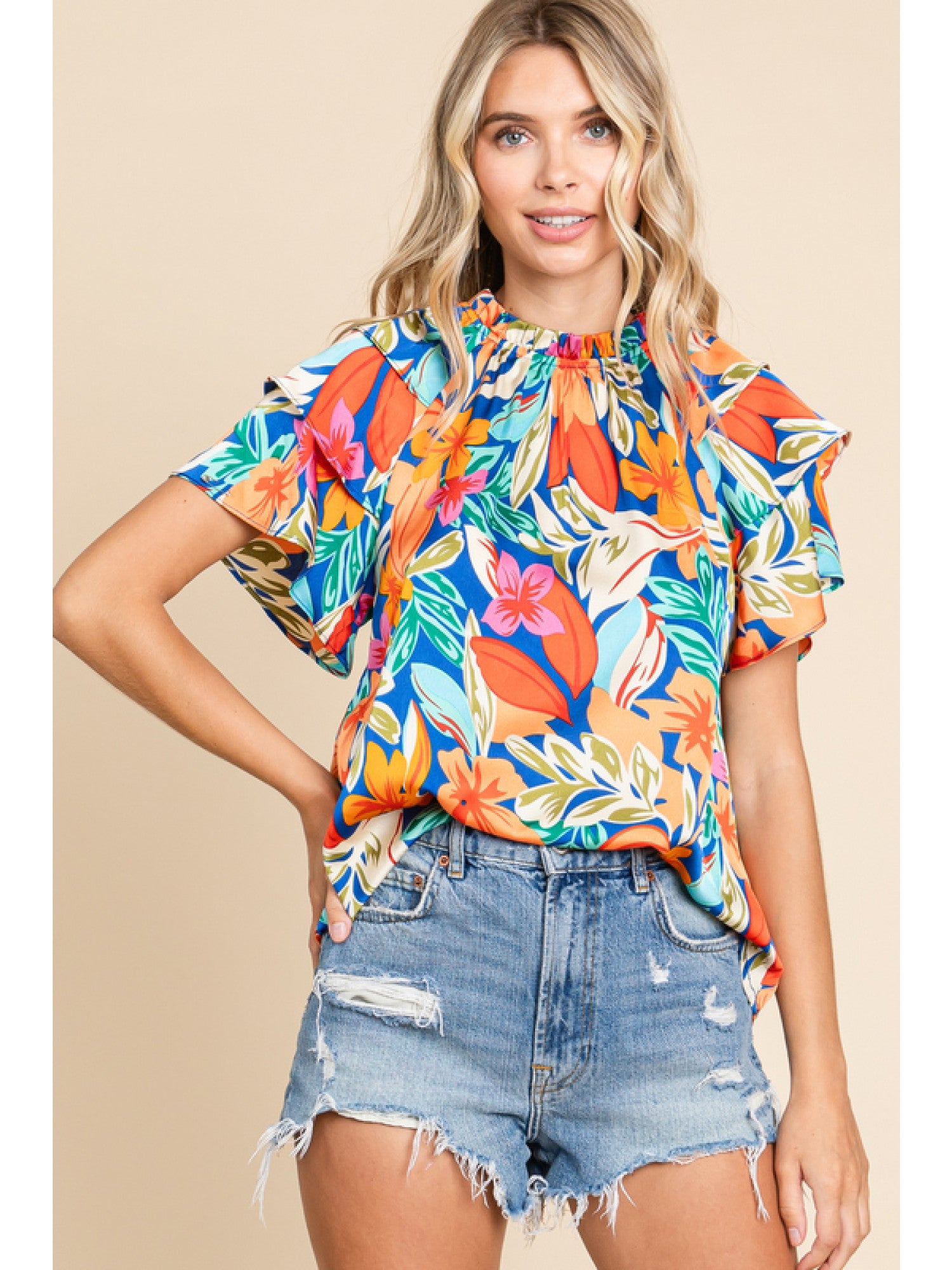 Orange and royal blue floral print top with double ruffled sleeves and a round neckline.