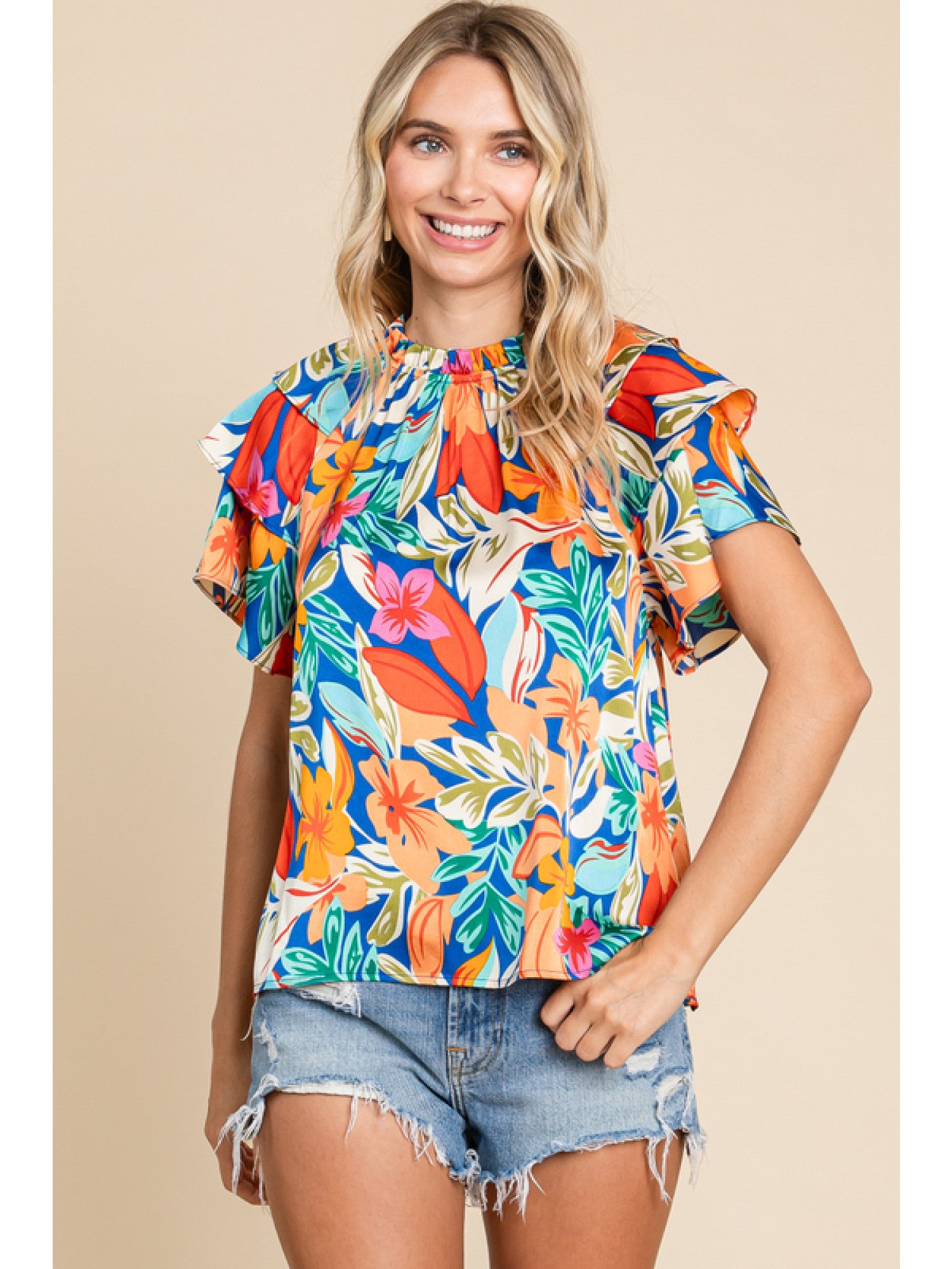 Orange and royal blue floral print top with double ruffled sleeves and a round neckline.