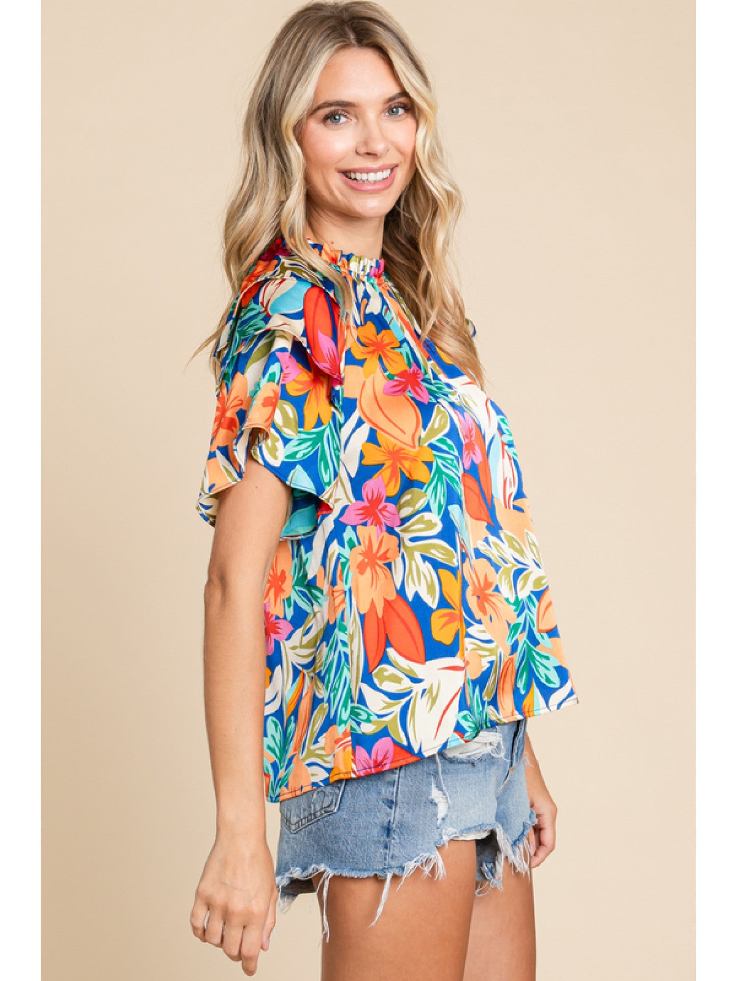Orange and royal blue floral print top with double ruffled sleeves and a round neckline.