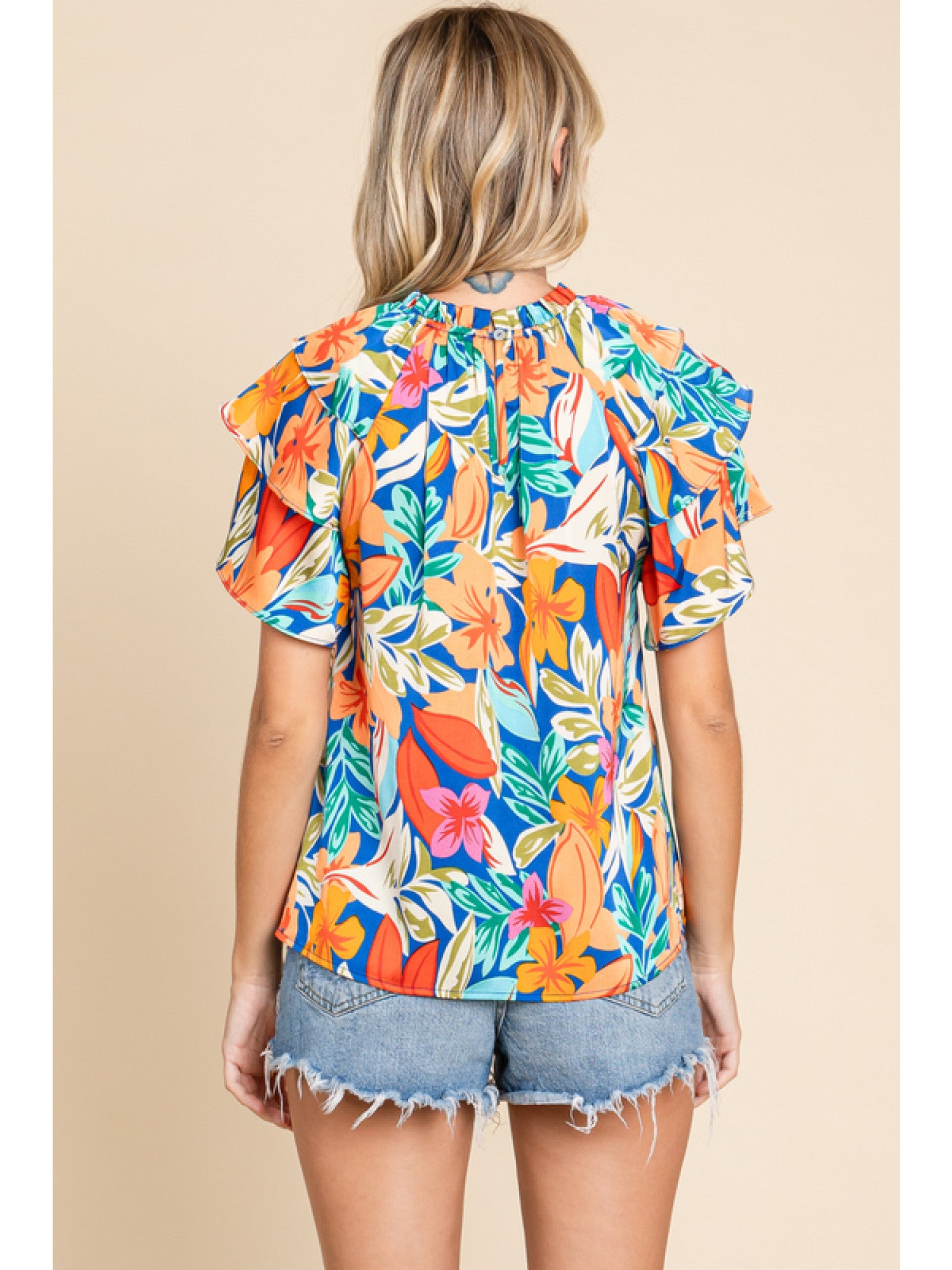 Orange and royal blue floral print top with double ruffled sleeves and a round neckline.