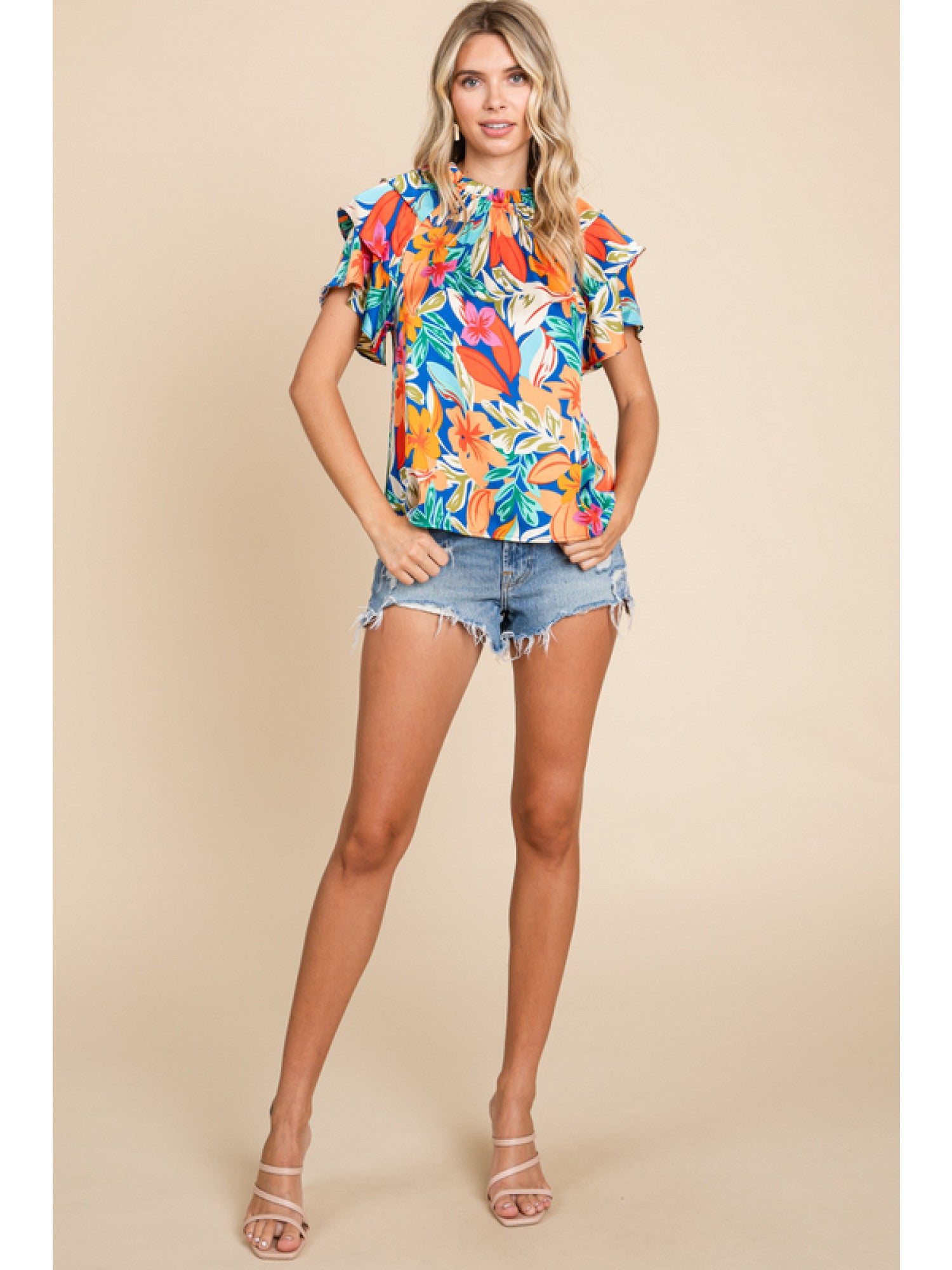 Orange and royal blue floral print top with double ruffled sleeves and a round neckline.