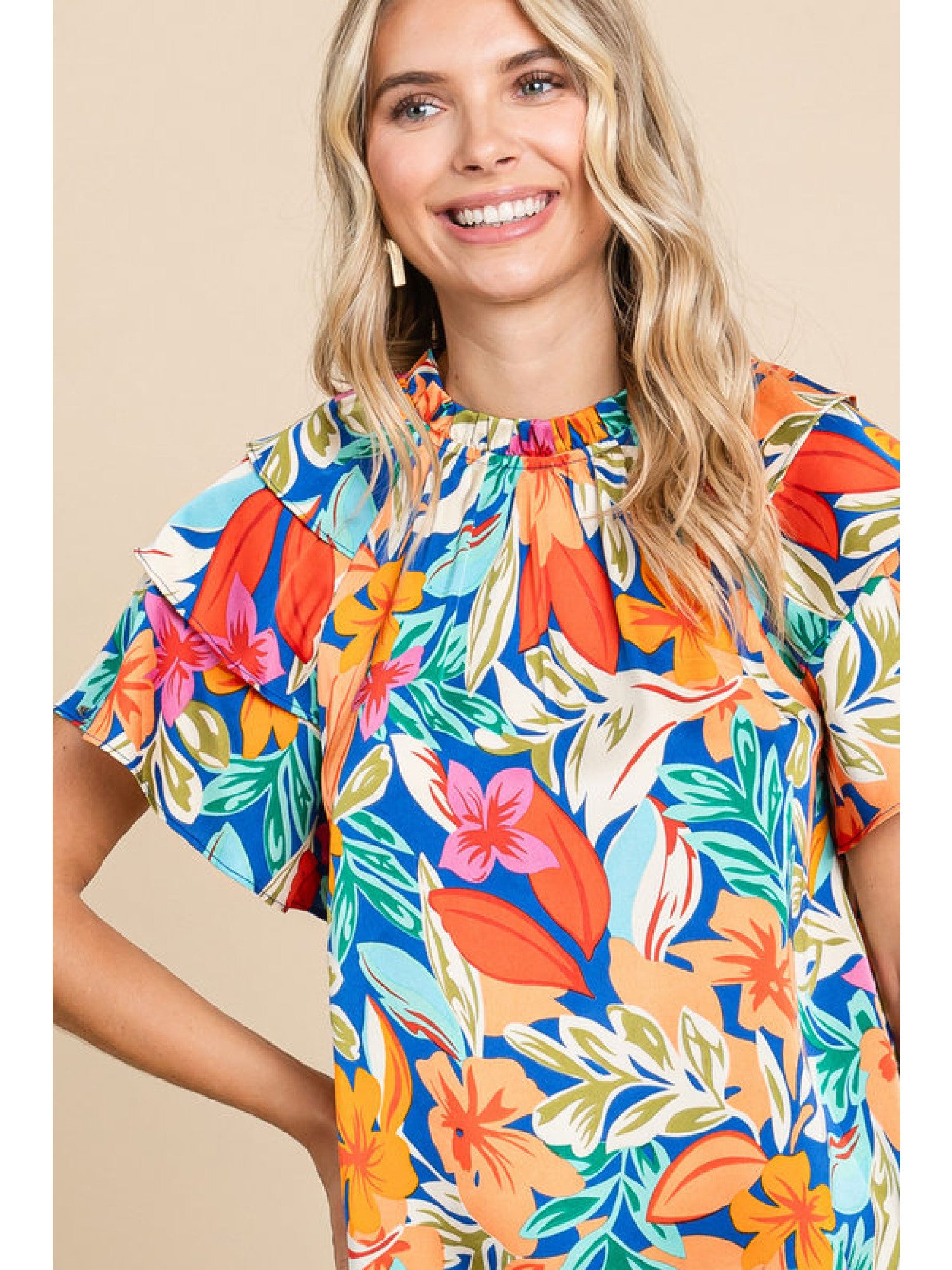 Orange and royal blue floral print top with double ruffled sleeves and a round neckline.