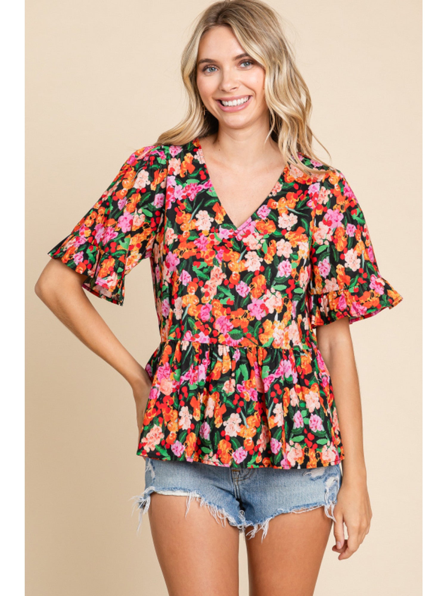 - Black Floral print peplum top with a V-neck, short sleeves, and frilled cuffs.
- Unlined, non-sheer, lightweight.