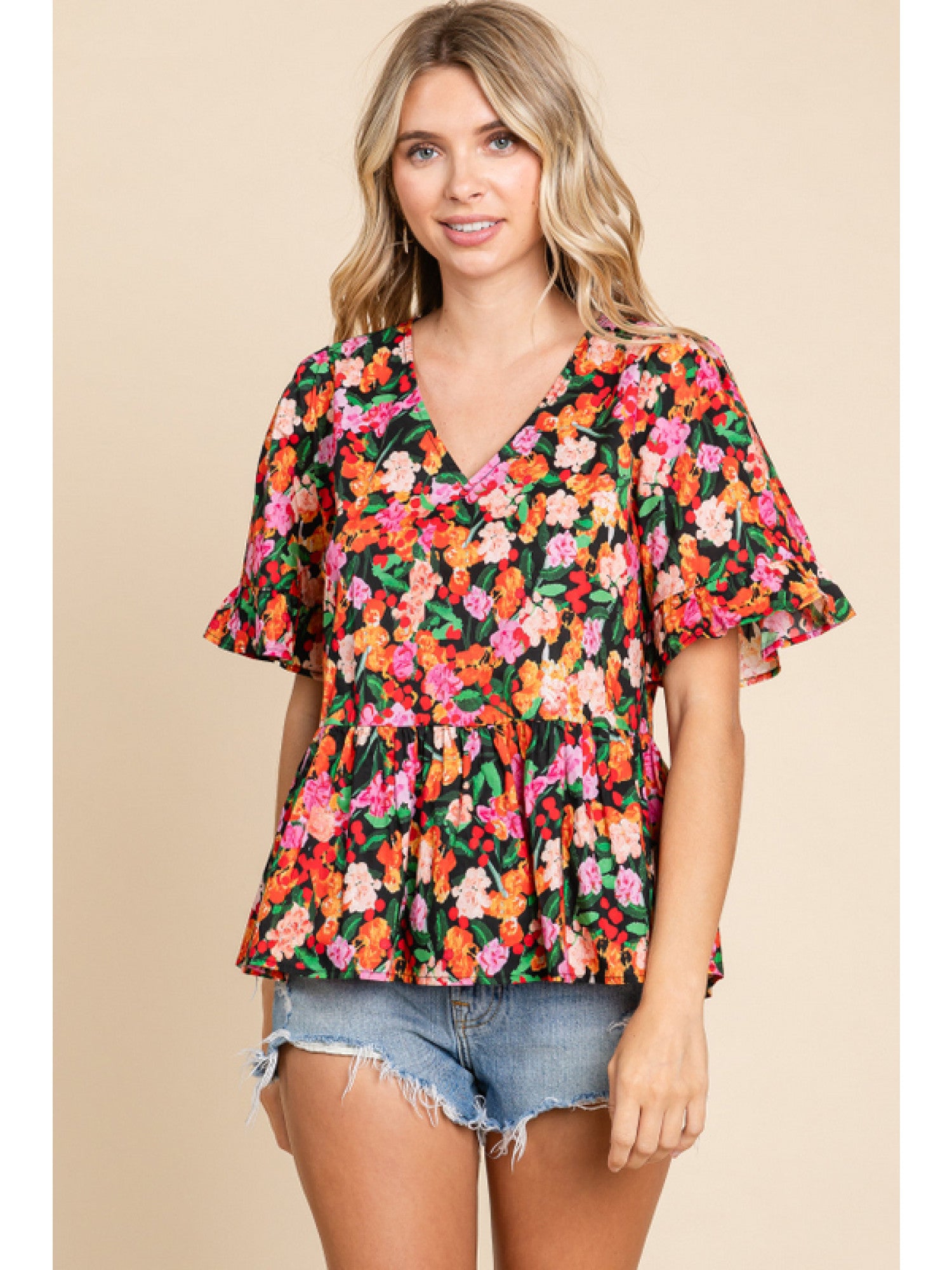 - Black Floral print peplum top with a V-neck, short sleeves, and frilled cuffs.
- Unlined, non-sheer, lightweight.