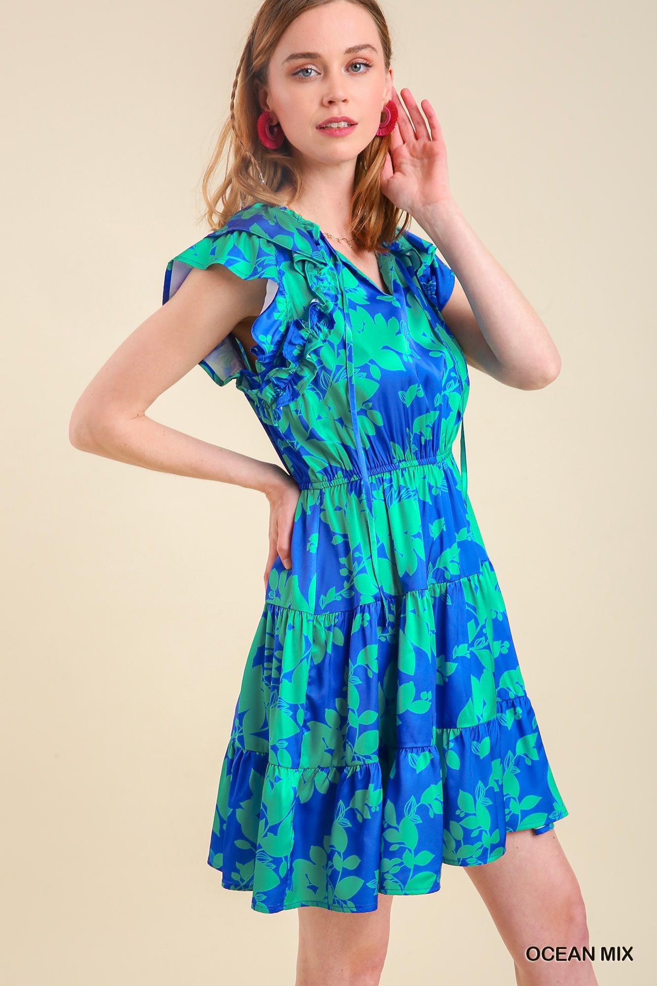 Women's blue and green floral tiered dress with stretch waist and short flutter sleeve.