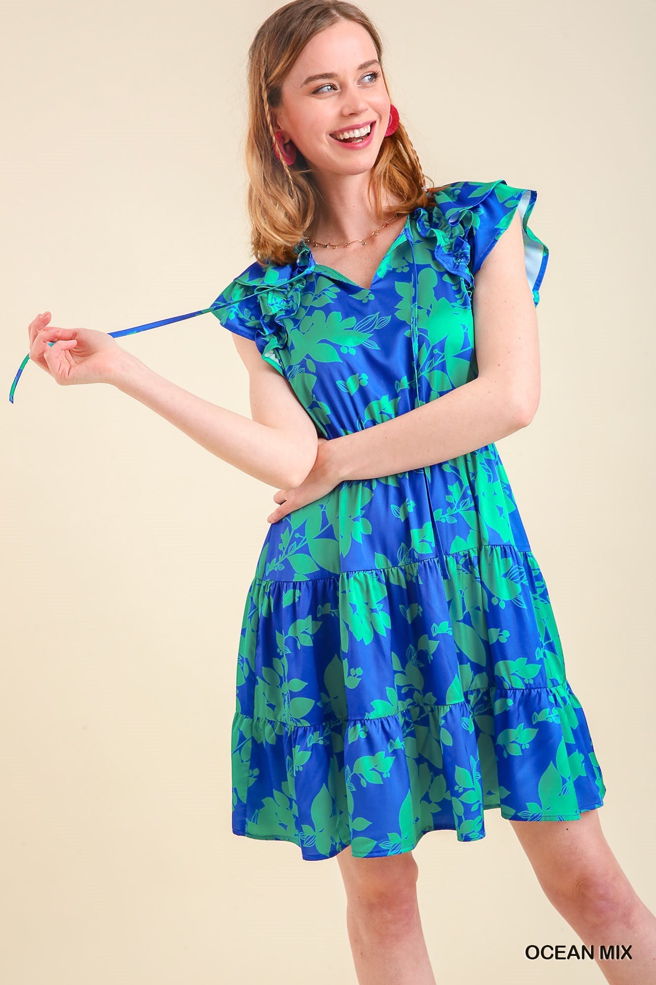 Women's blue and green floral tiered dress with stretch waist and short flutter sleeve.