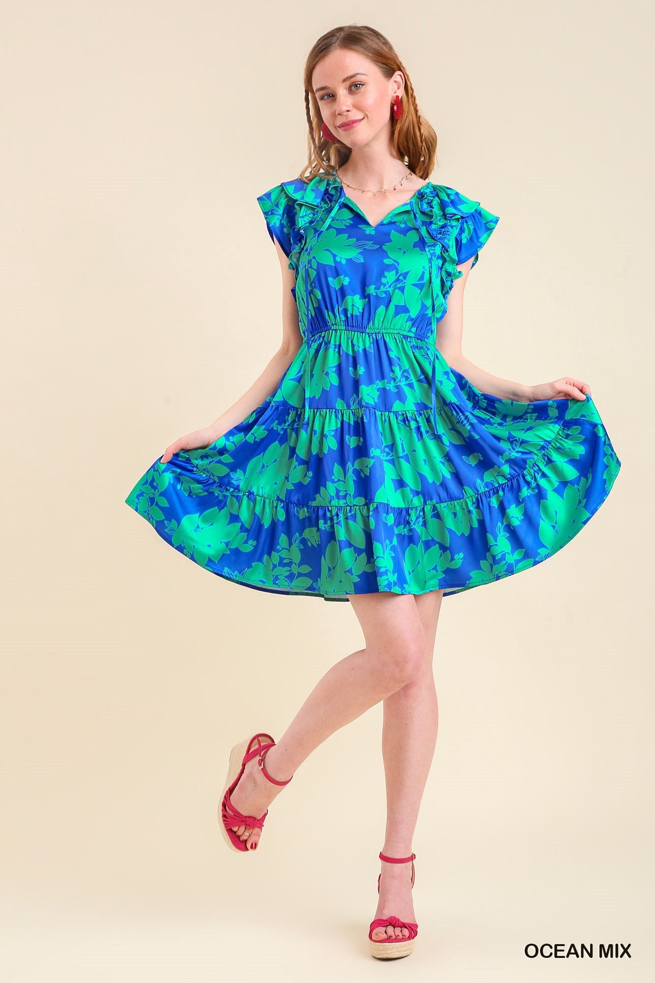Women's blue and green floral tiered dress with stretch waist and short flutter sleeve.