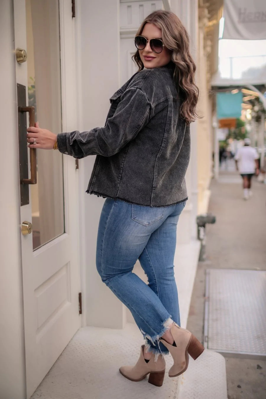 This trendy corduroy jacket features two button down chest pockets and a raw frayed hemline.