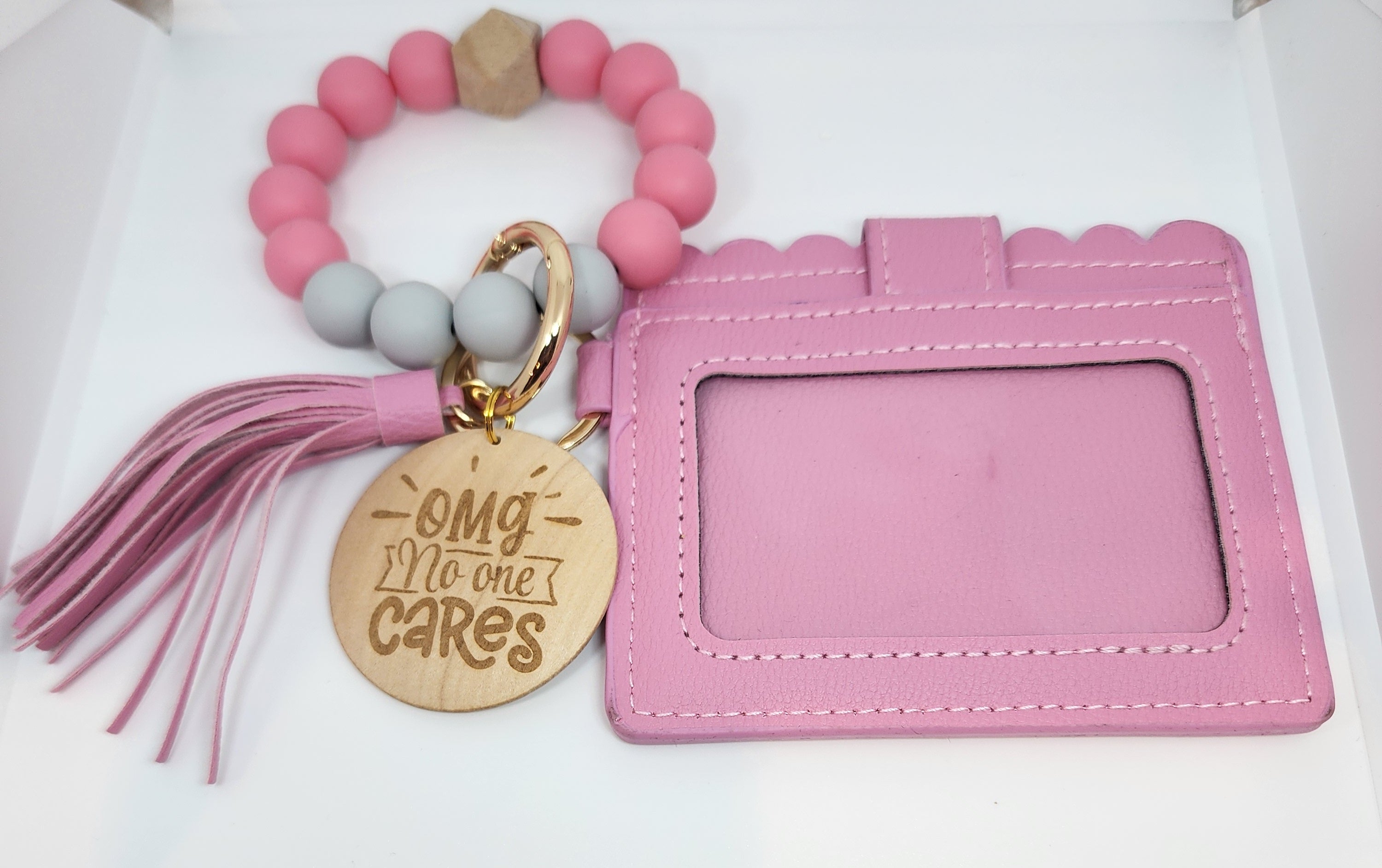Pink beaded wristlet keychain with tassel and credit card holder.