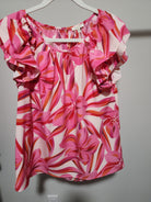 - Fuchsia, Red, Orange, Pink and White Floral Double Ruffle Flounce Shoulder Top
- Print top with U-neck featuring wrinkle, back buttoned closure, layer flounce shoulder, and curved hemline.
- Non-sheer, lightweight.