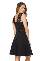 A short black dress with lace sleeves and waist pockets, featuring sequin accents on the front of the sleeves.