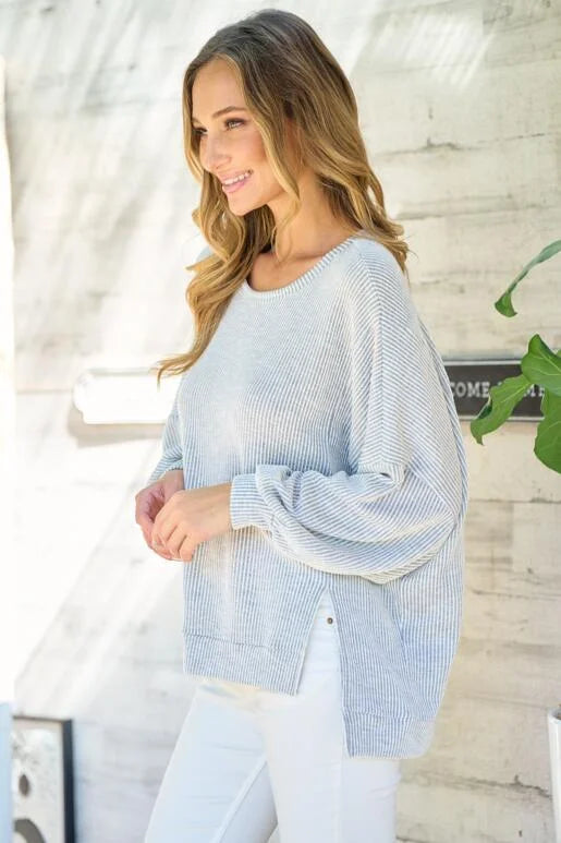 Grey Oversized Fit Long Sleeve Knit Top. Unique hemline with slit side and Bubble sleeves.
High and low silhouette.
