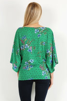 Green Floral Curvy Top with Bell Sleeves and Round Neckline, fitted at the hips.