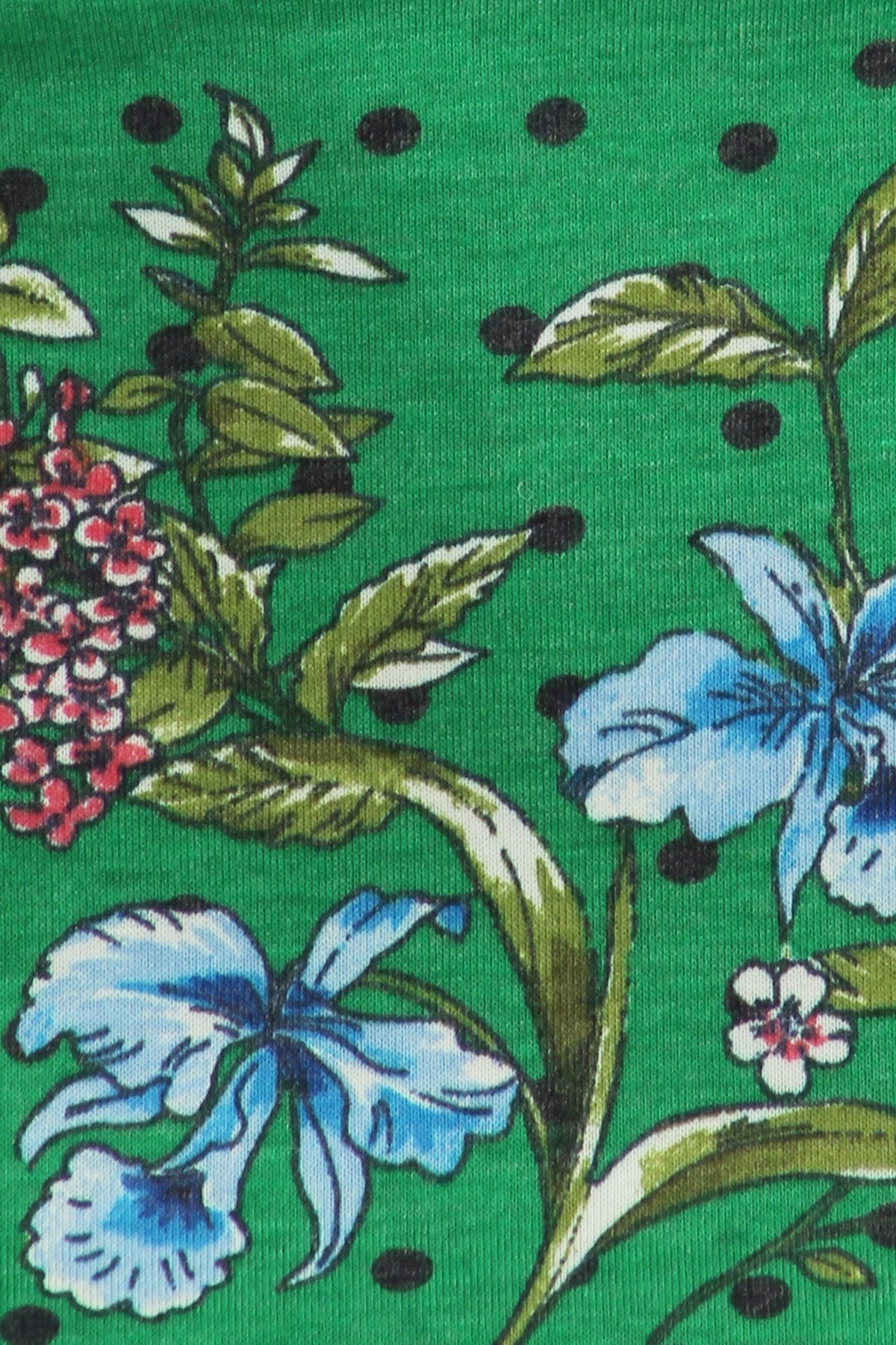 Green Floral Curvy Top with Bell Sleeves and Round Neckline, fitted at the hips. Closeup of Fabrick pattern.