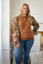 Simple Elegance Curvy Size Black Jacquard Organza sleeve and sweater mixed top, with round neckline and elastic arm bands. Wear with sleeves down or pull sleeves up to elbow for a bell sleeve look.